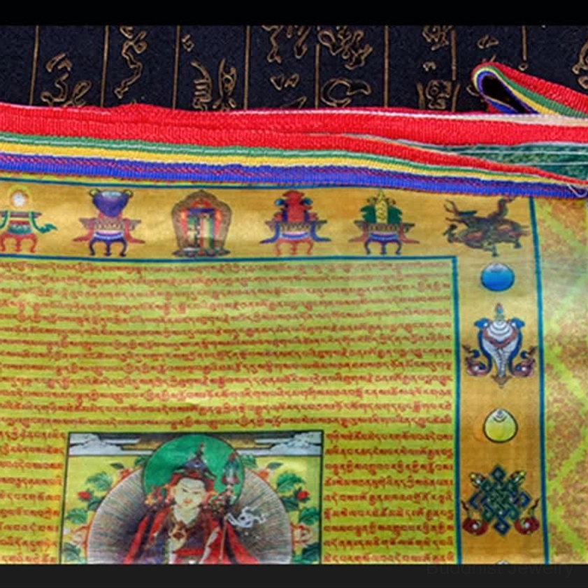 Close-up detail of Buddhist prayer flag showing sutra text Padmasambhava image and traditional auspicious patterns