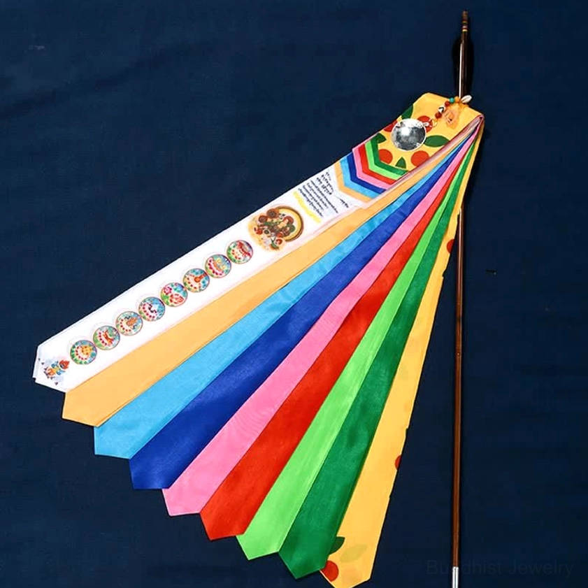 Fanned colorful Buddhist prayer flags showing rainbow silk strips with printed sutras and auspicious motifs