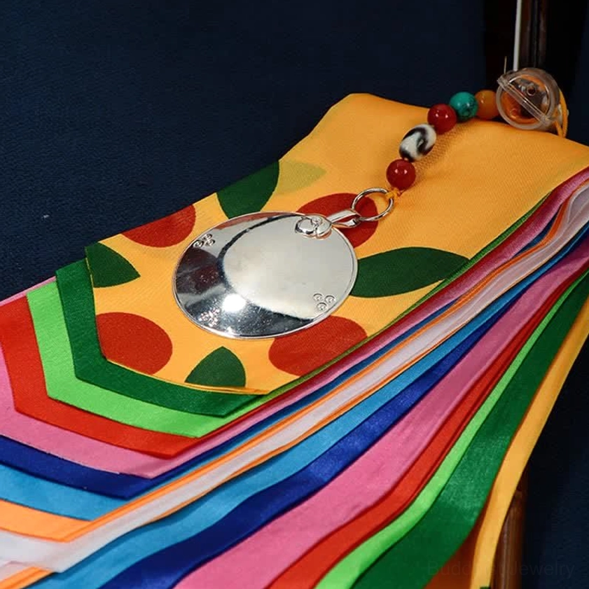 Finished Buddhist prayer flag decoration featuring metal mirror pendant and multi-color silk strips
