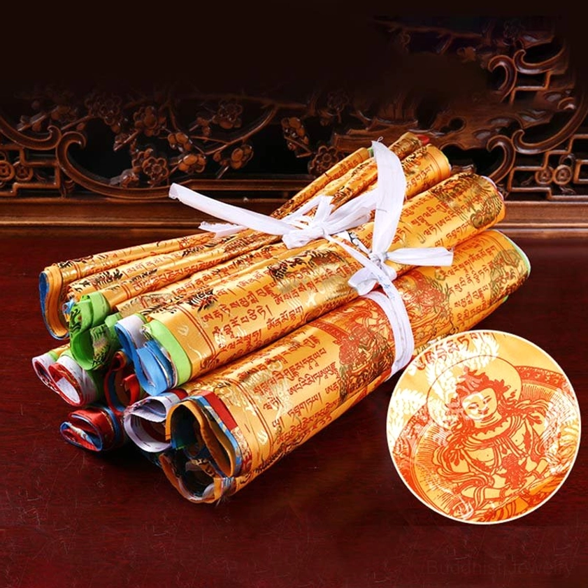 White buddhist prayer flag showing sacred sutra text and spiritual deity iconography with gilded printing