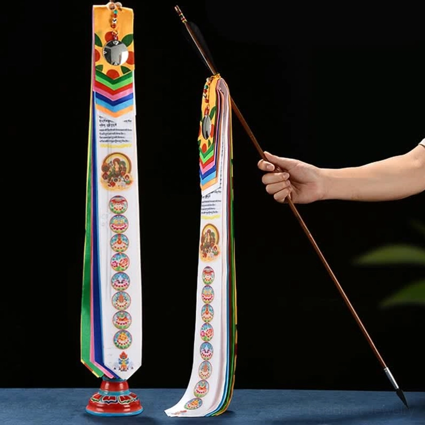 Buddhist prayer flag with windhorse and auspicious symbols displayed on wooden pole with metal mirror decor