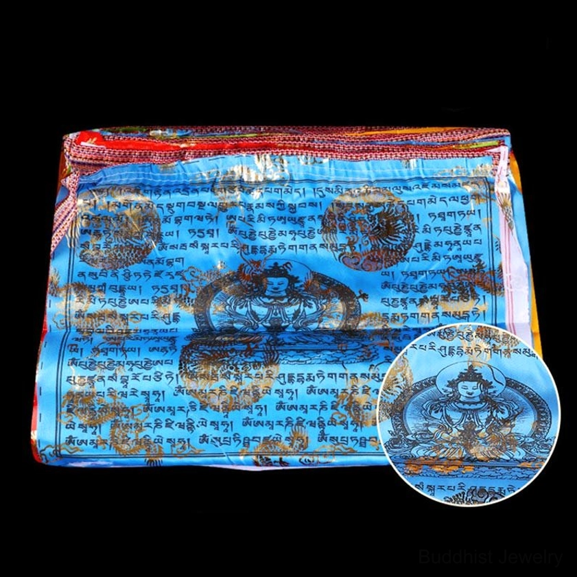 Folded buddhist prayer flag set with blue panel featuring deity print and closeup detail on black background