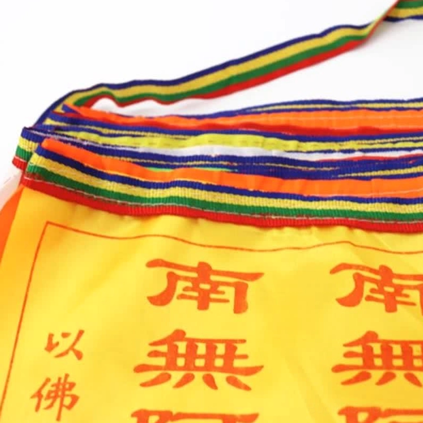 Buddhist prayer flags showing individual flag quality and hand-printed design details, close-up of Windhorse motif and sutra text