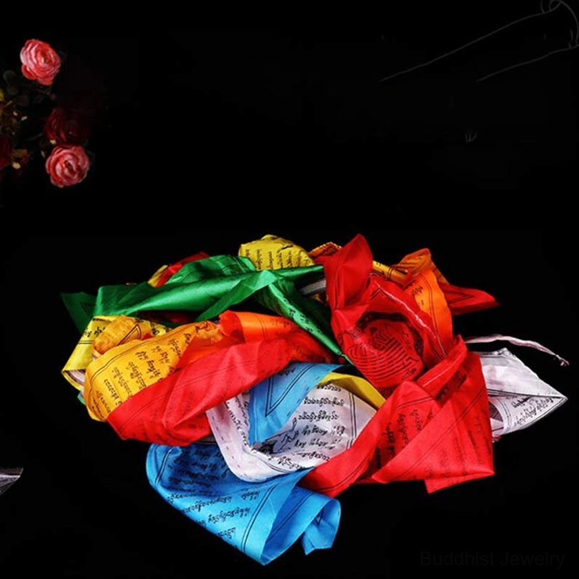 Loose piled Buddhist prayer flags in five traditional colors showing natural rolled state with decorative styling