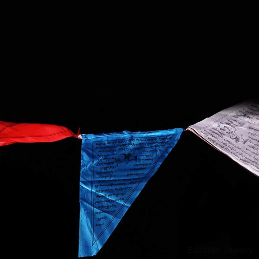 Unfolded Buddhist prayer flag display showing blue fabric with printed scriptures and educational materials
