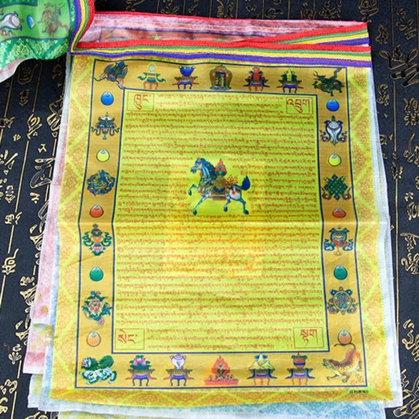 Stacked windhorse Buddhist prayer flags with central lungta motif sutra text and auspicious Buddhist symbols