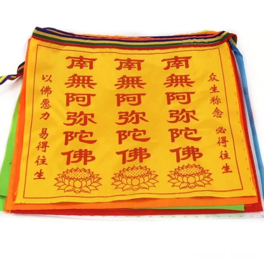 Buddhist prayer flags yellow satin fabric featuring printed sutras and lotus motifs, flat studio view of prayer flag set components