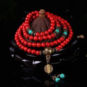 Red turquoise and turquoise 108-bead Buddhist prayer mala with bronze hardware, overhead studio view