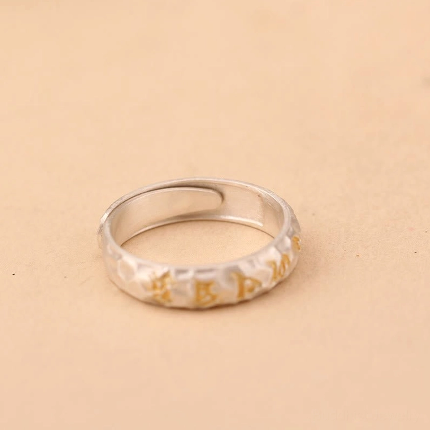 Buddhist prayer ring back view displaying open adjustable design and full mantra wrap-around construction