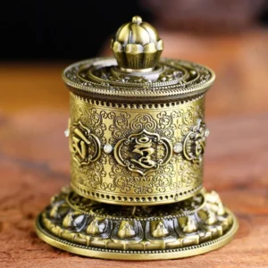 Antique bronze Buddhist prayer wheel car decoration with embossed Om Mani Padme Hum mantra and lotus patterns, front flat view