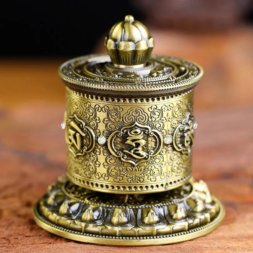 Antique bronze Buddhist prayer wheel car decoration with embossed Om Mani Padme Hum mantra and lotus patterns, front flat view