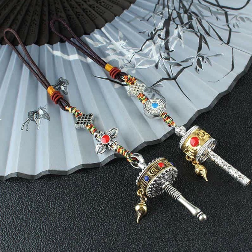 Buddhist prayer wheel with gemstone inlay and braided cord - spiritual healing and mindfulness tool
