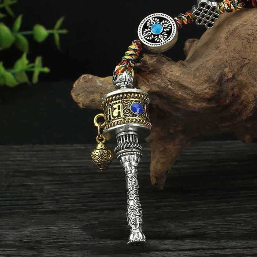 Buddhist prayer wheel hanging decor with silver-gold tone, blue gemstone inlay, round decorative accessory, and carved handle