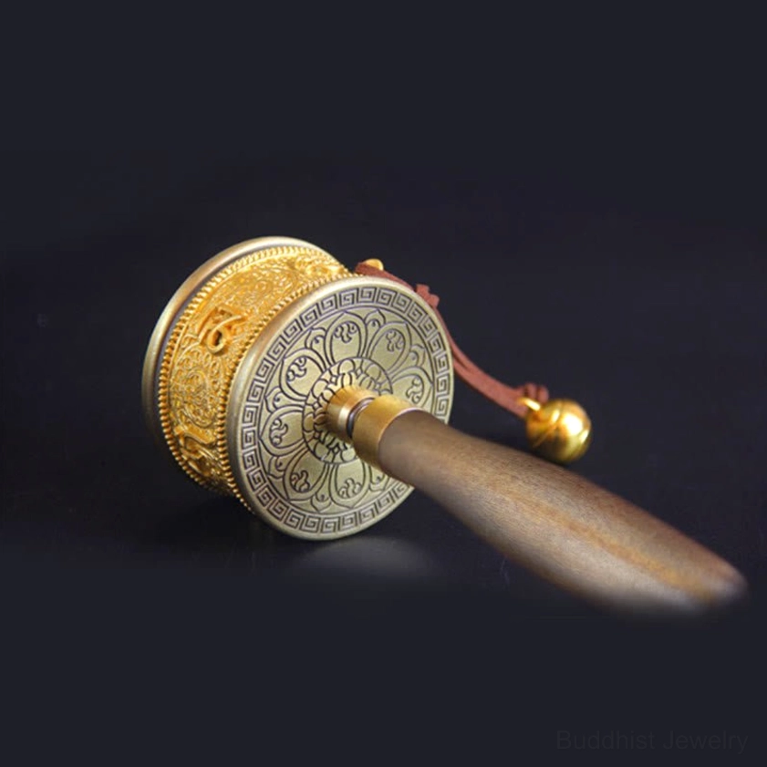 Top angled view of meditation prayer wheel showing intricate floral engraved copper end cap and craftsmanship