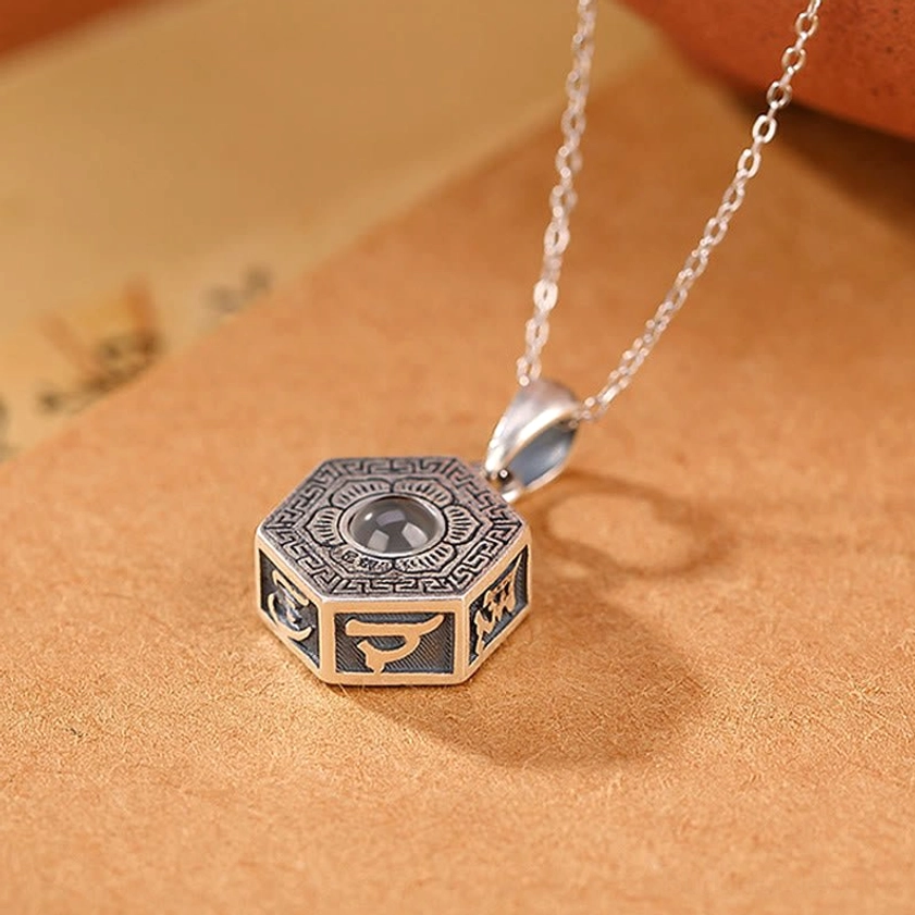 Buddhist Projection Necklace with Hexagonal Pendant Design and 5mm Nano Lens - Low Angle View Showing Central Lens Detail
