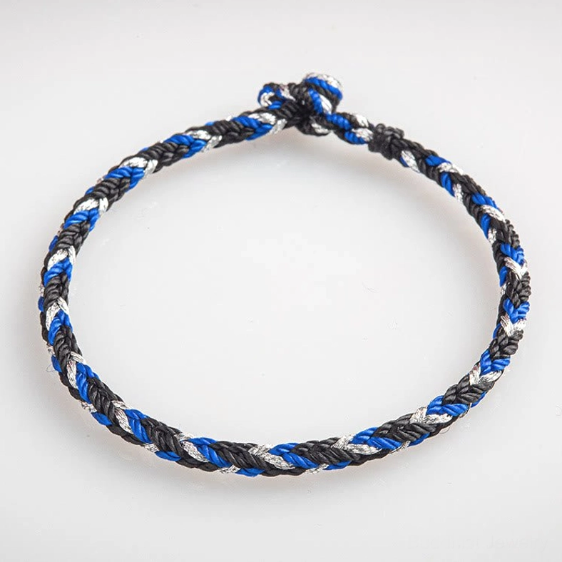 Front flat lay of Buddhist prosperity bracelet with neat tri-color braiding and hand-tied knot design