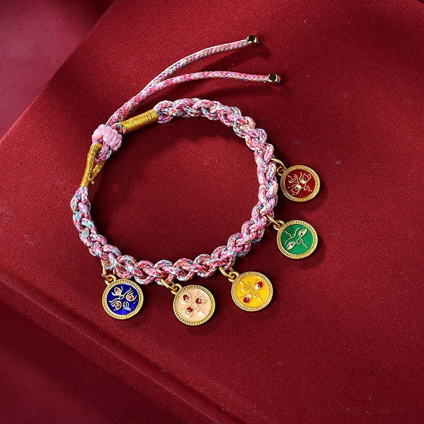 Single Buddhist five gods of wealth string bracelet with pink and light purple woven rope and enamel fortune pendants on burgundy background