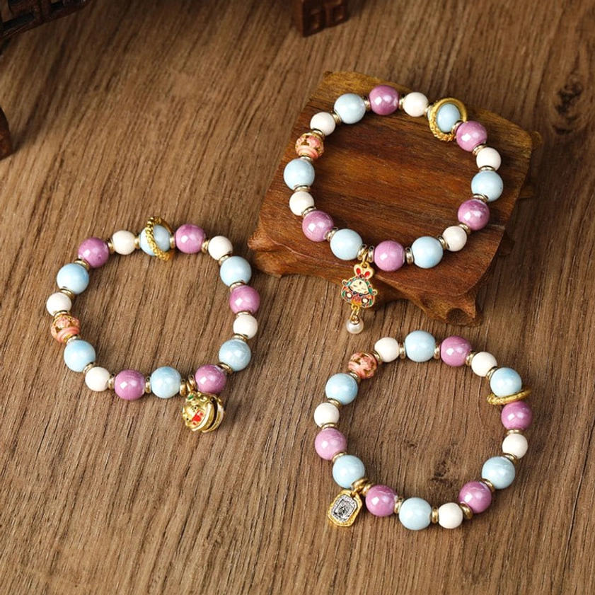 Buddhist prosperity and protection bracelet with liuli glass and porcelain beads featuring spiritual charm pendants for wealth and abundance