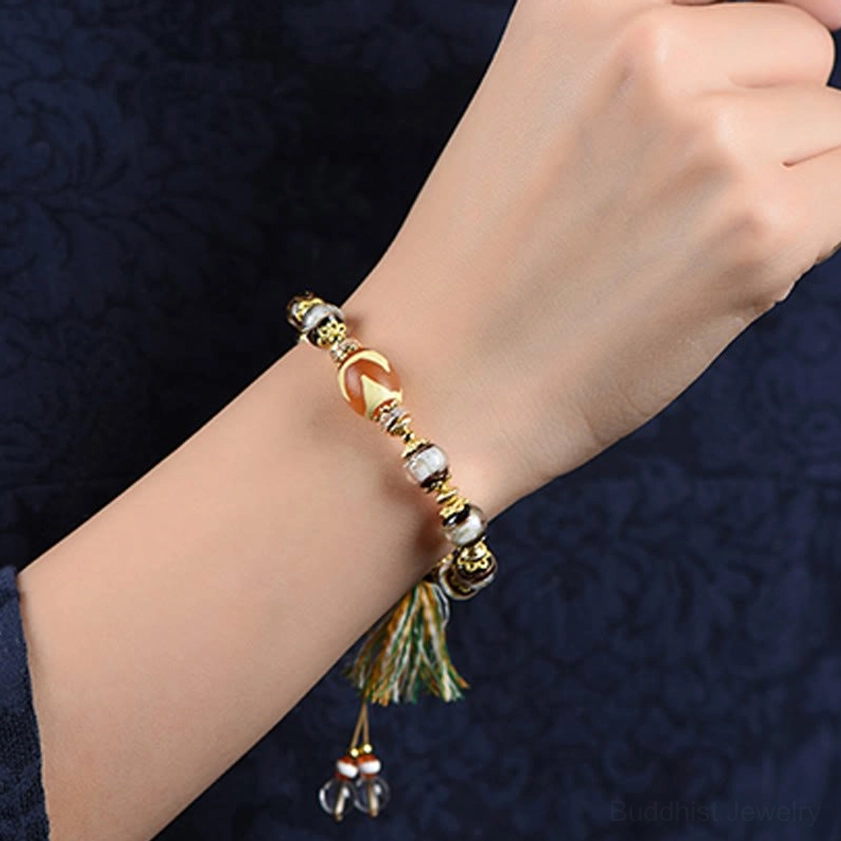 Buddhist prosperity and protection bracelet with nine-eye dzi bead for wealth, health, and spiritual blessing