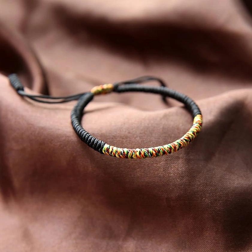 Black and multicolor Buddhist King Kong Knot braided bracelet with protective amulet design and adjustable fit for wrist protection