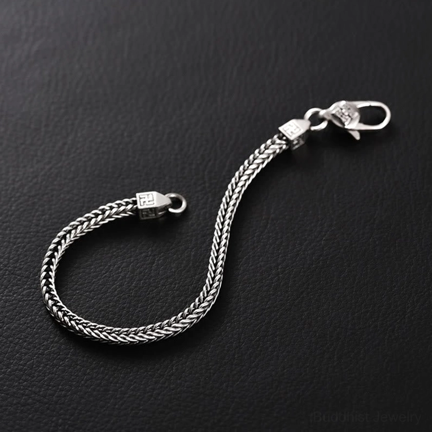 Vintage silver tone Buddhist Vajra swastika bracelet showing secure lobster clasp and braided chain detail