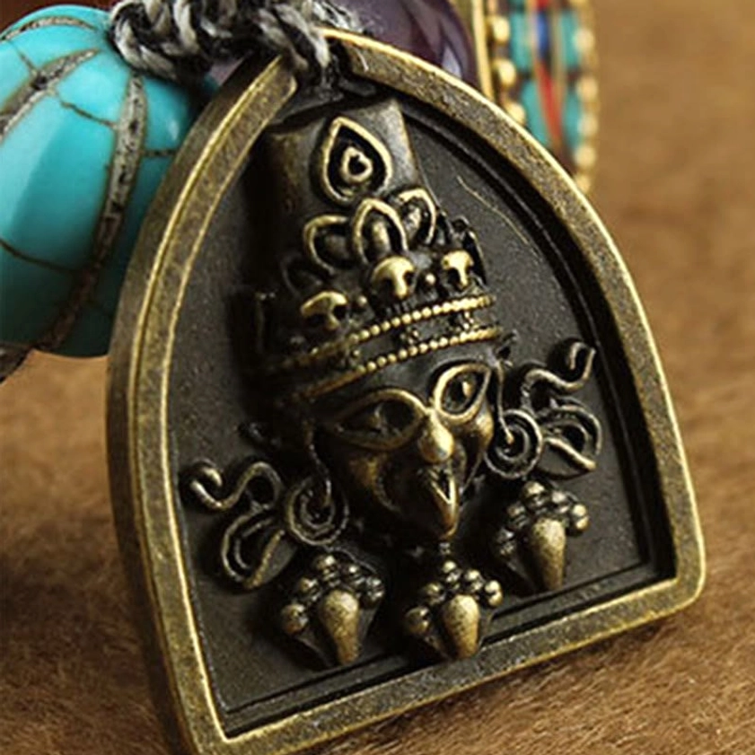 Buddhist protection bracelet flat lay showing complete piece with all spiritual beads and deity charm clearly visible