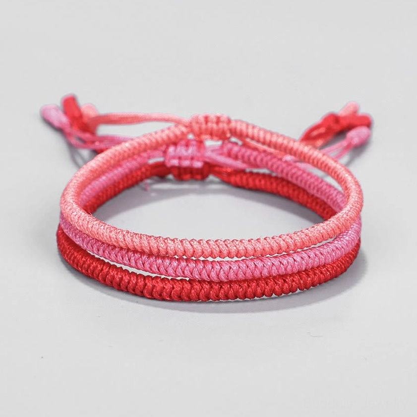 Single Buddhist protection bracelet with pink-to-deep-red ombre weave and neat king kong knot design, front top view