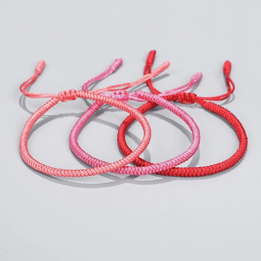 Handmade Buddhist protection bracelet with adjustable sizing, spiritual knot detail, and natural woven string craftsmanship
