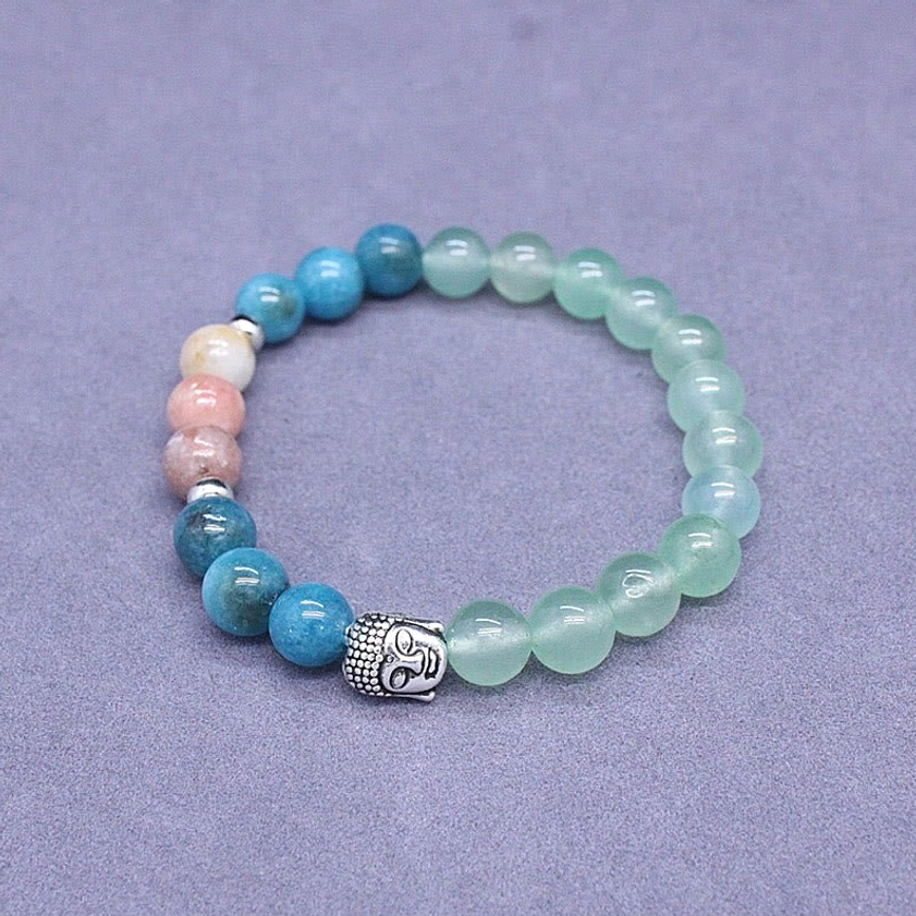 Buddhist gemstone protection bracelet displayed on wooden surface with natural crystals
