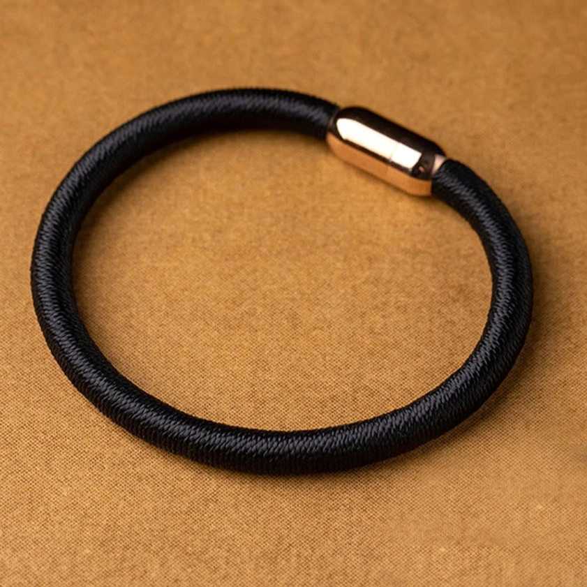 Buddhist protection bracelet collection showing red and black cord variety