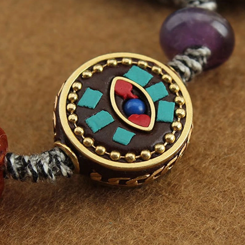 Lifestyle shot of Buddhist protection rope bracelet on wrist showing how adjustable sizing fits comfortably