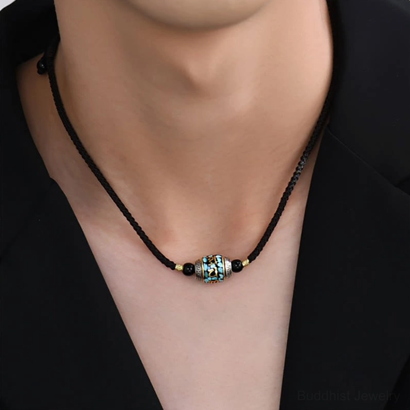 Buddhist protection necklace Dzi Bead with turquoise inlay and vintage metalwork detail