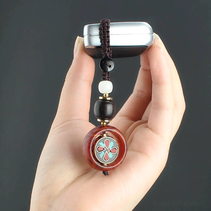 Full product presentation of rotating Buddhist keychain with braided cord, beads, and spiritual charm from multiple angles