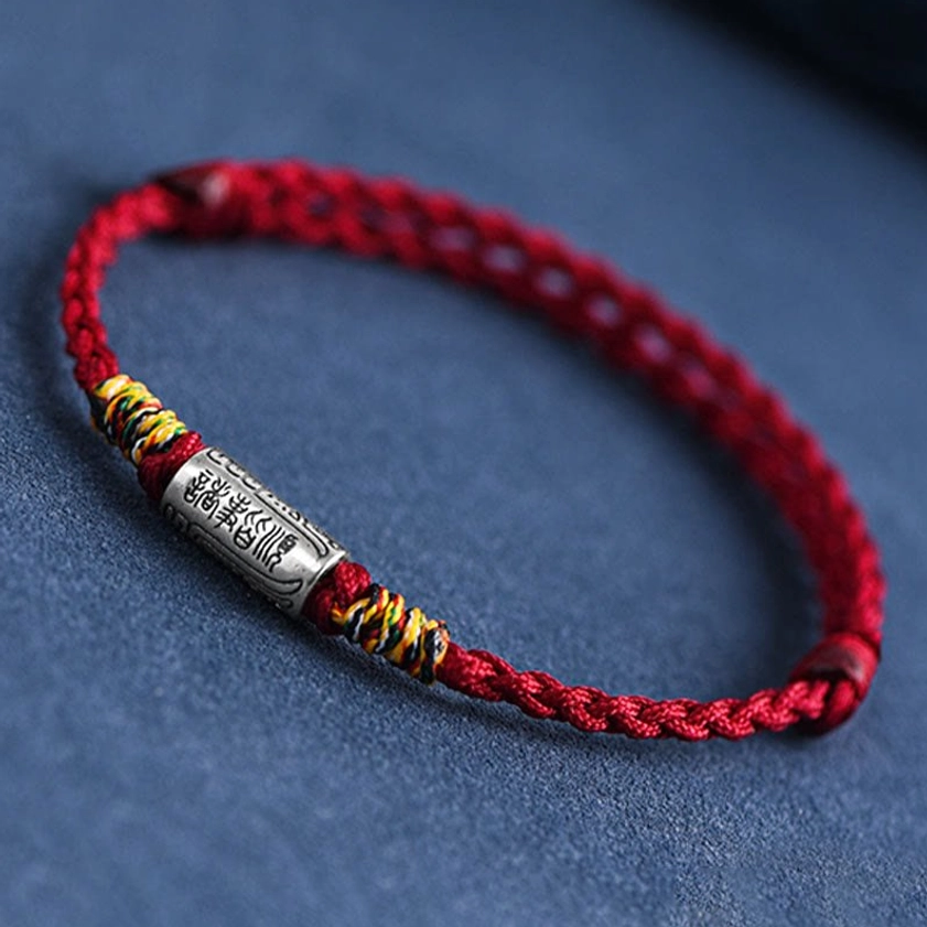 Buddhist red string bracelet with 925 sterling silver hardware, showing knot details and rope craftsmanship from above