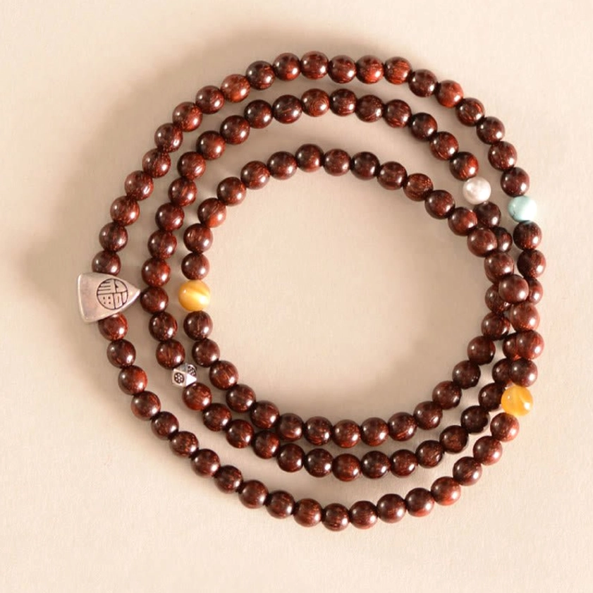 Red sandalwood Buddhist bracelet featuring 925 sterling silver Fu character charm on neutral background
