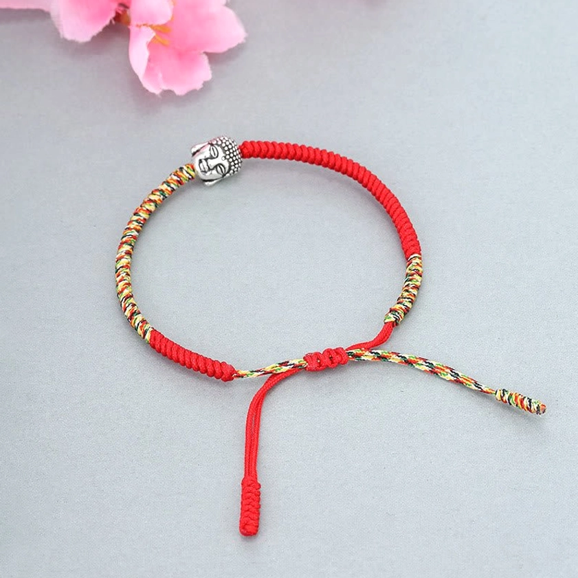 Adjustable Buddhist King Kong knot red string bracelet with dual drawstrings, front flat lay on neutral background