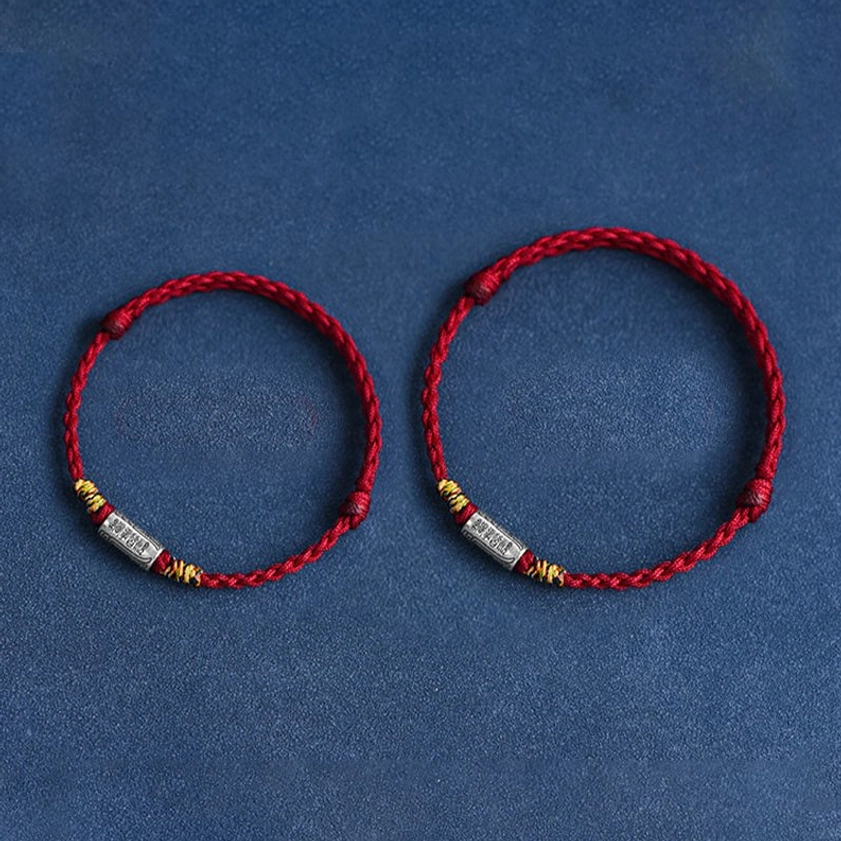 Handcrafted Buddhist red string bracelet with natural rope texture and authentic 925 silver charm, artisanal craftsmanship display