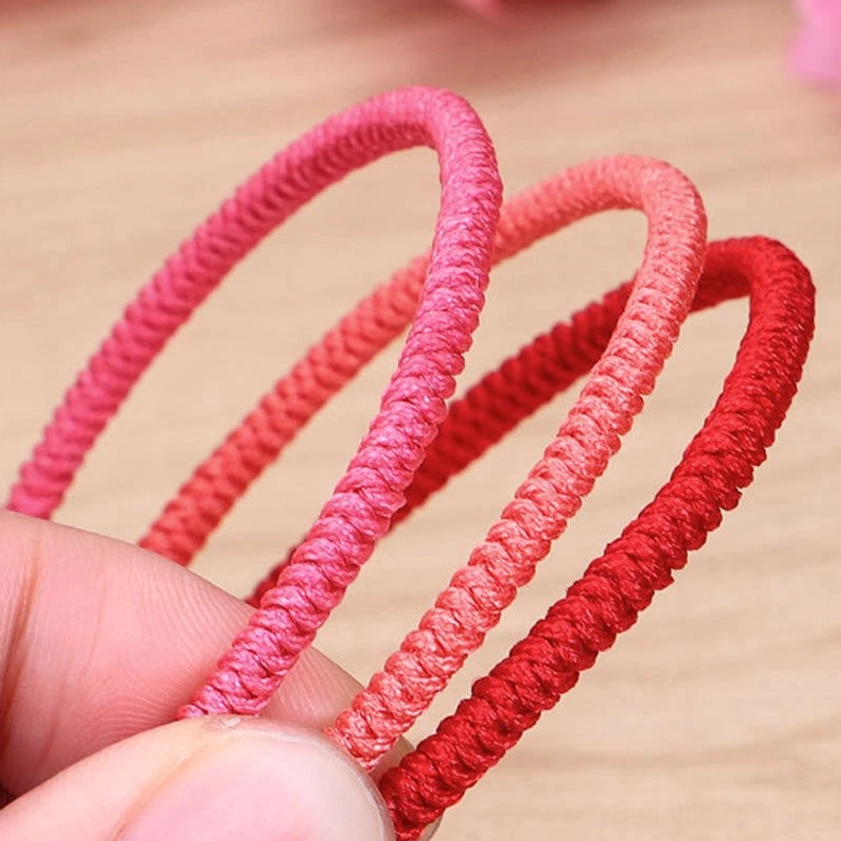 Buddhist red string bracelet close-up showing intricate woven knot pattern and natural fiber quality for daily wear