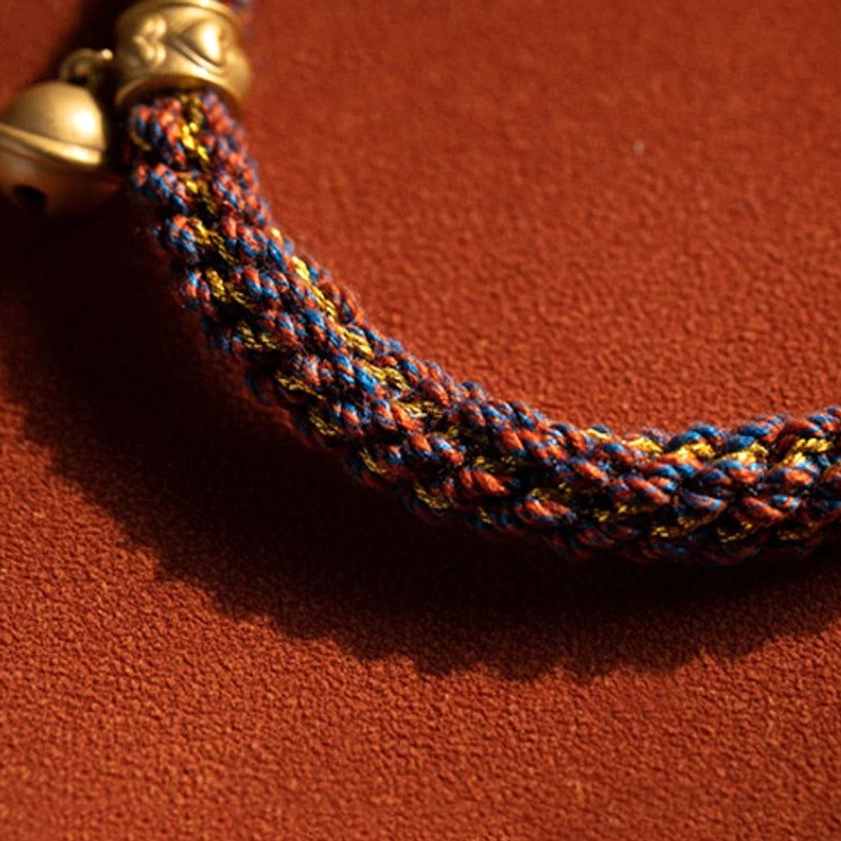 Complete handwoven Buddhist red string bracelet with brass bell clasp and multicolor woven cord