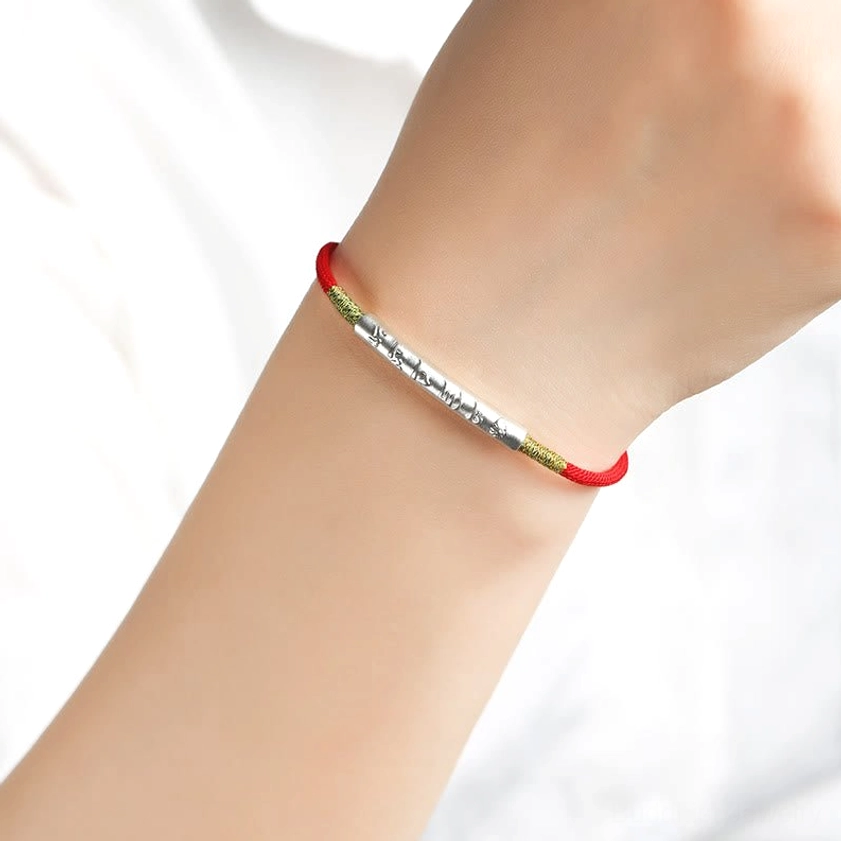 Buddhist mantra red string bracelet showing adjustable sizing and authentic handmade craftsmanship