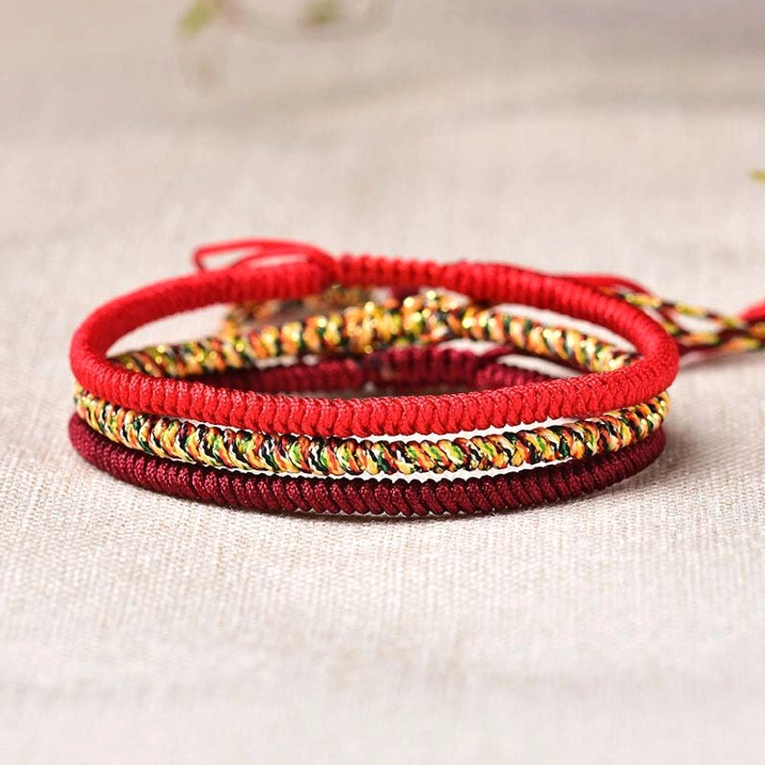 Buddhist red string bracelet set of three handmade bracelets featuring solid red and mixed-tone woven designs with adjustable closures