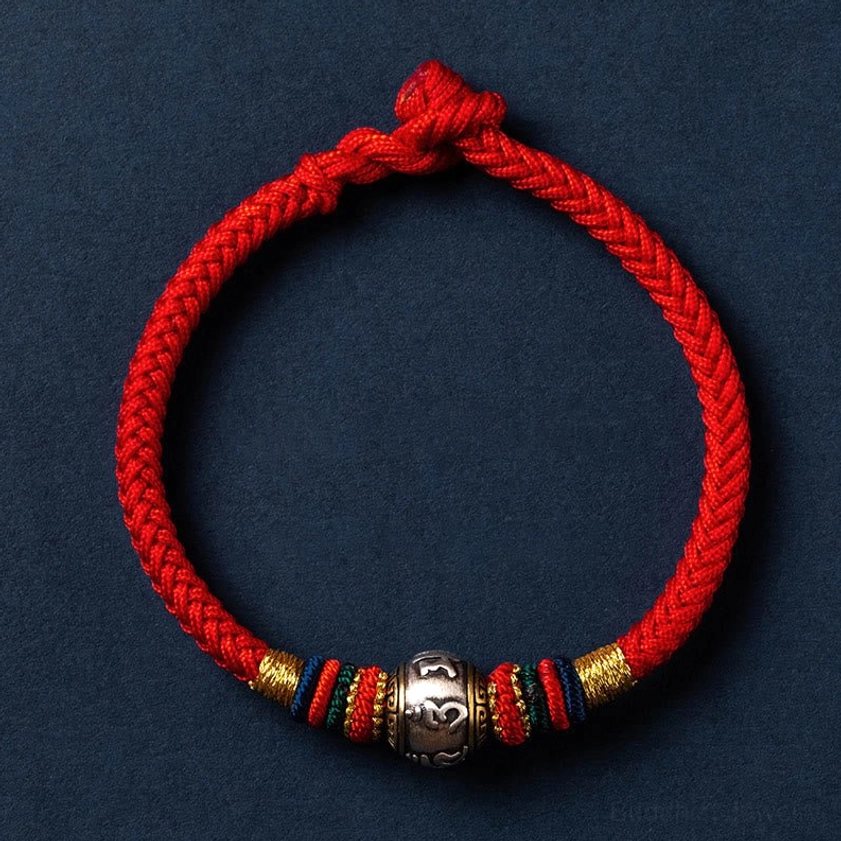 Bright red Buddhist braided bracelet with silver Om Mani Padme Hum mantra bead and colorful accent threads with adjustable knot
