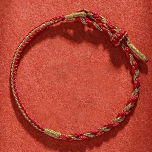 Red and gold twisted handmade Buddhist string bracelet with adjustable woven knot closure for protection