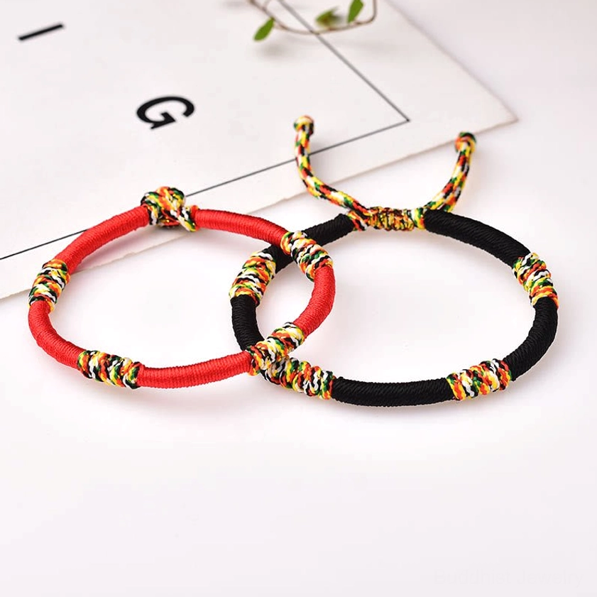 Buddhist red string protection bracelet with sacred knots representing courage resilience and spiritual connection