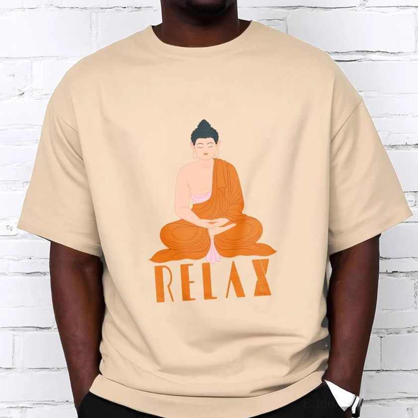 Male model wearing tan beige Buddhist Relax graphic t-shirt with Buddha print, front view on brick wall background