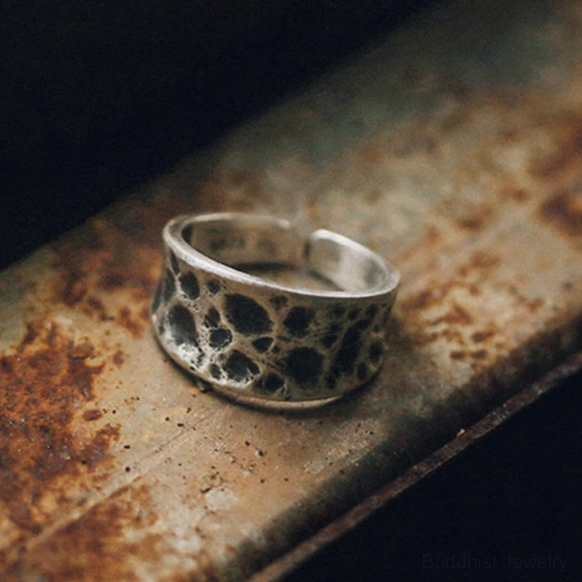 Sterling silver protection ring front view highlighting curved wide band with recessed textured cracked pattern
