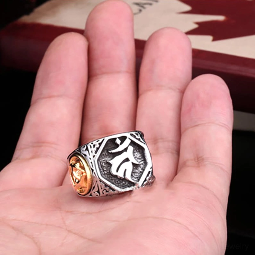 Sanskrit blessing ring resting on palm showing full band width and dual-tone finish detail
