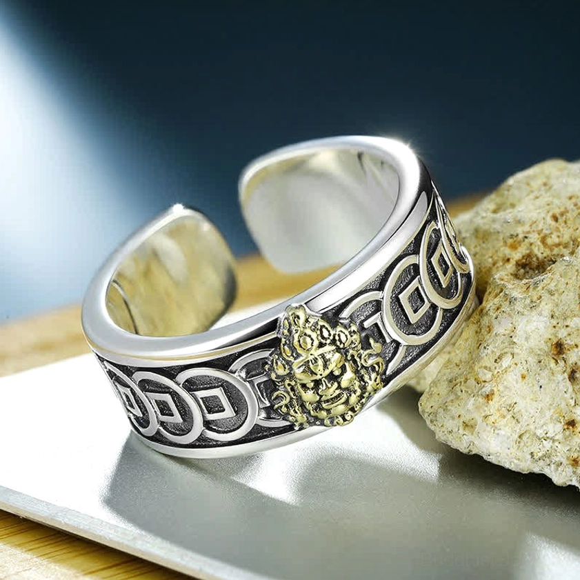 Adjustable Buddhist protection ring side angle displaying two-tone silver and brass metal finish with coin details