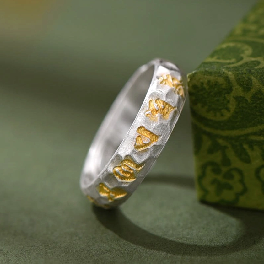 Buddhist mantra ring worn on hand showing wearable size and comfort fit with hammered surface details