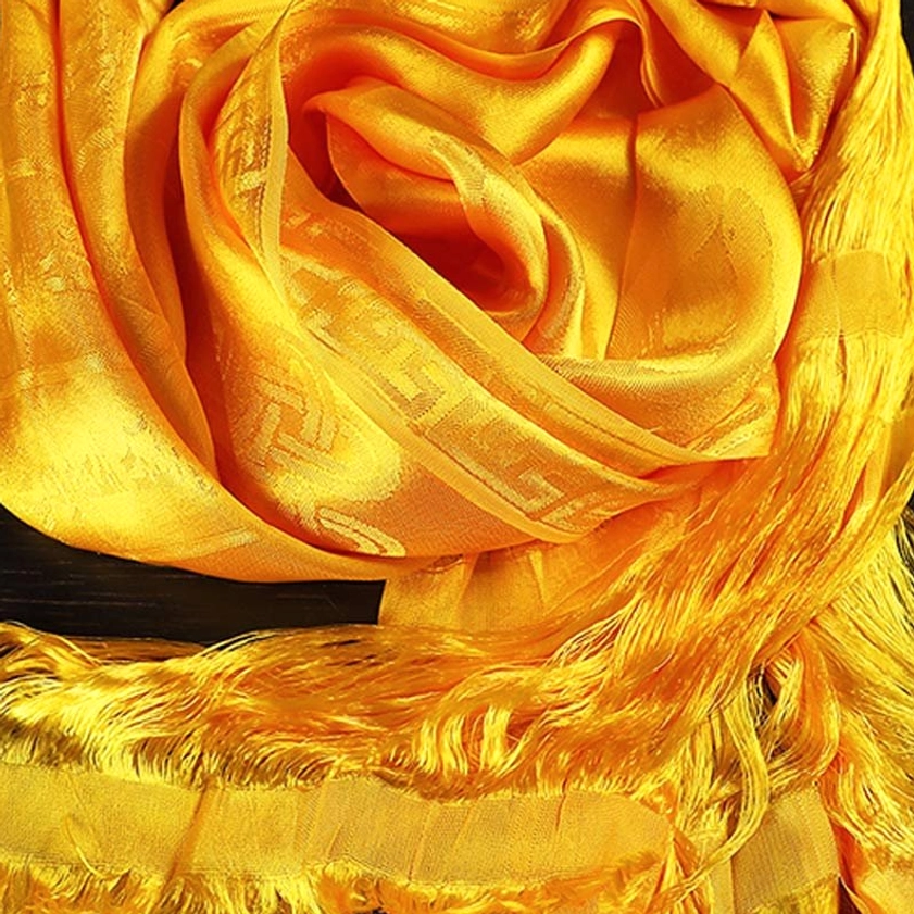 Sacred Buddhist khata blessing scarf with traditional jacquard weave pattern and frayed silk-like tassel finish